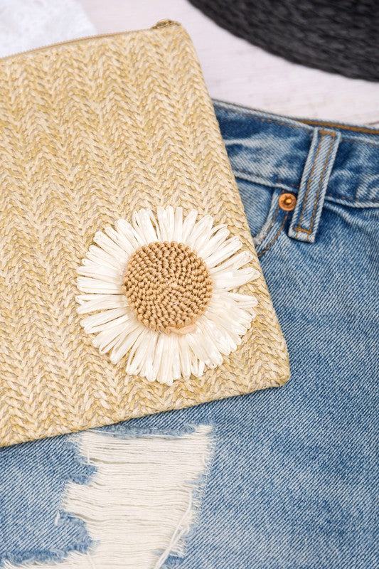 Daisy Wristlet ClutchDaisy Wristlet ClutchWoven Exterior DetailMeasurement 10.5" x 7.25"Removable Vegan Leather WristletPolyester LiningOpen InteriorExterior Material: StrawDaisy Embelli