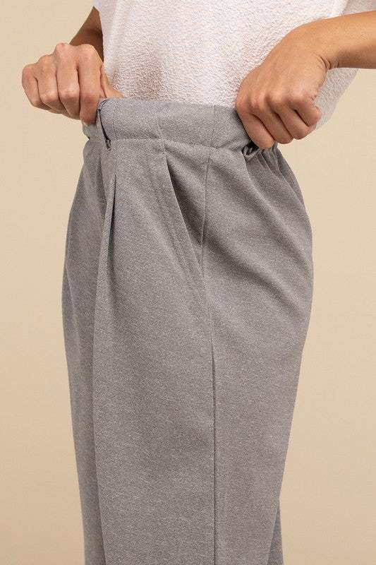 Waffle Trouser PantsElevate your everyday style with these waffle trouser pants. Crafted from textured waffle-knit fabric, they offer a perfect blend of comfort and sophistication. The