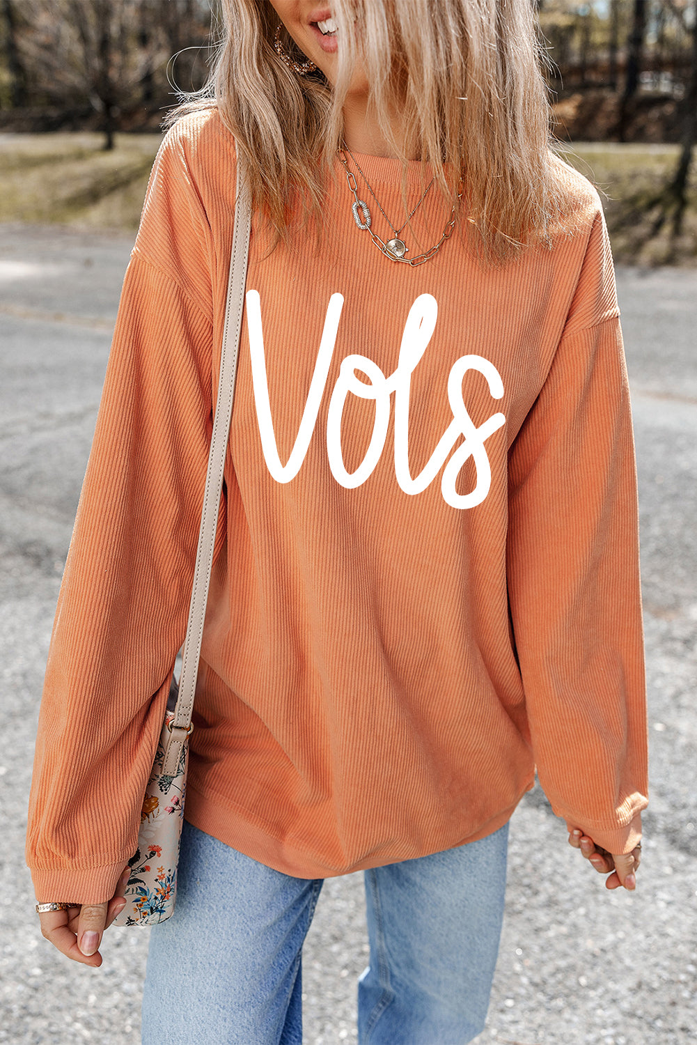 Orange Vols Letter Graphic Crinkle Ribbed Oversized SweatshirtMaterial:100%Polyester

• Vibrant orange hue adds a pop of color to your wardrobe, perfect for standing out in a crowd. 
• Oversized fit provides comfort and a rel