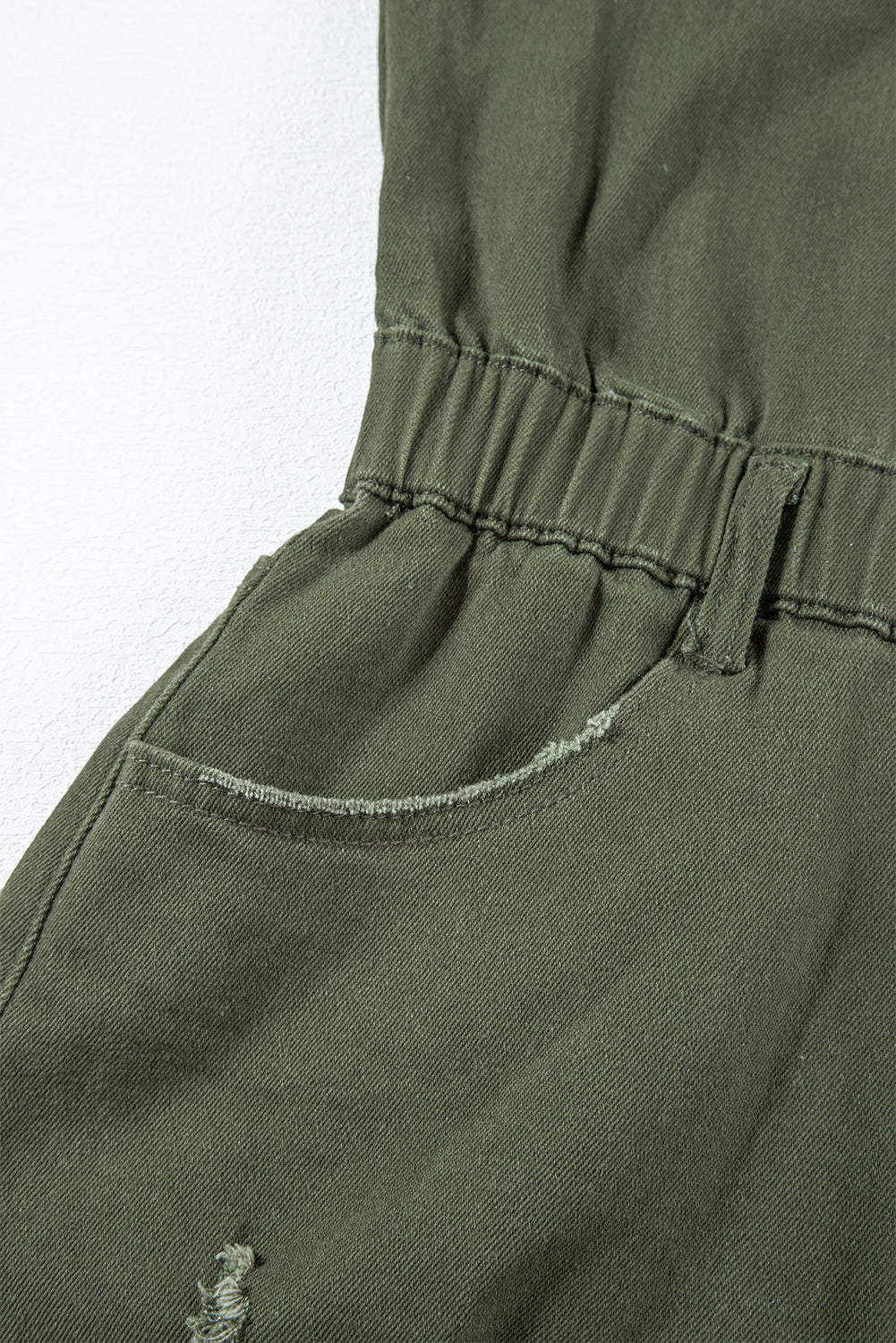 Moss Green Distressed Frayed Denim RomperMaterial:98%Cotton+2%Elastane

• This romper offers a comfortable and stretchy fit for all-day wear.
• The moss green hue brings a touch of nature-inspired charm, 