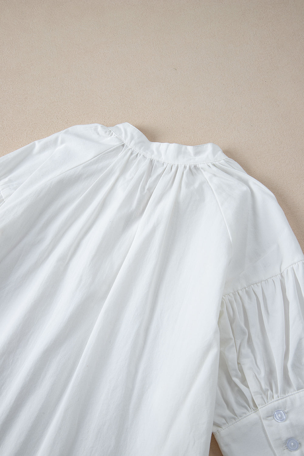 White Solid Color Ruched Bubble Sleeve V Neck ShirtMaterial:100%Cotton

• The ruched detailing on the sleeves adds a touch of texture and visual interest, making this top a standout choice for any occasion. 
• Craf