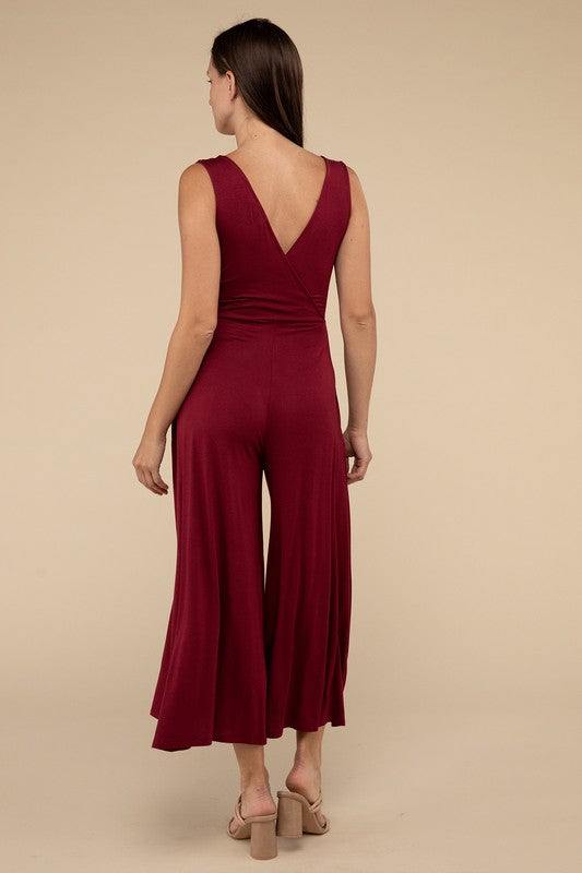 Surplice Neckline Sleeveless JumpsuitThe Surplice Neckline Sleeveless Jumpsuit exudes effortless elegance and modern sophistication. Featuring a surplice neckline, this jumpsuit offers a chic and flatte