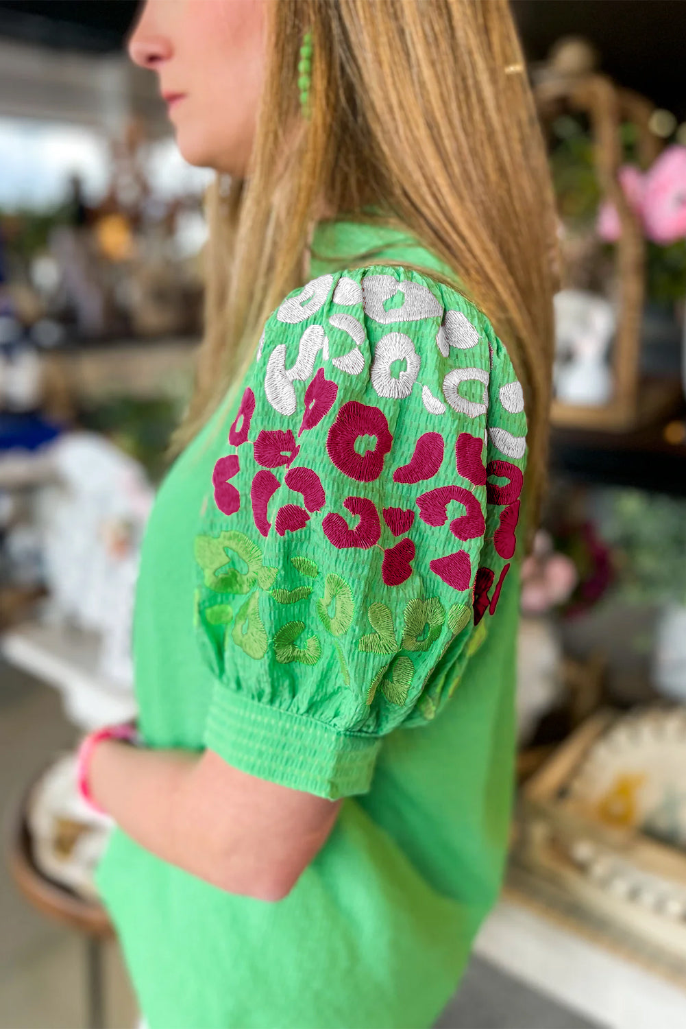 Green Leopard Embroidered Sleeve Textured BlouseMaterial:100%Polyester



		Fierce and fabulous: This textured blouse features a bold leopard, flattering puff sleeves, and a V-neck for a statement look.
	
	
	