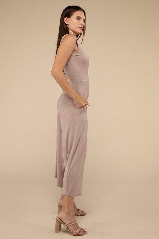 Surplice Neckline Sleeveless JumpsuitThe Surplice Neckline Sleeveless Jumpsuit exudes effortless elegance and modern sophistication. Featuring a surplice neckline, this jumpsuit offers a chic and flatte