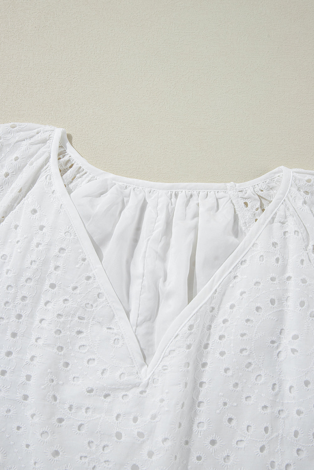 White Eyelet Embroidered V Neck Puff Sleeve BlouseMaterial:100%Cotton

• Delicate white eyelet embroidery adorns this charming blouse, adding a touch of elegance to your outfit. 
• The V-neck design creates a flat