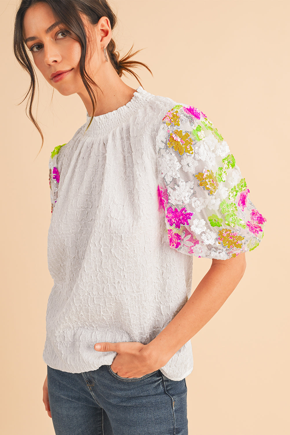 White Smocked Neck Sequin Flower Puff Sleeve Textured TopMaterial:100%Polyester



		The Top features a smocked neckline and sequin flower embellishments for a feminine and glamorous look.
	
	
		With its puff sleeves,