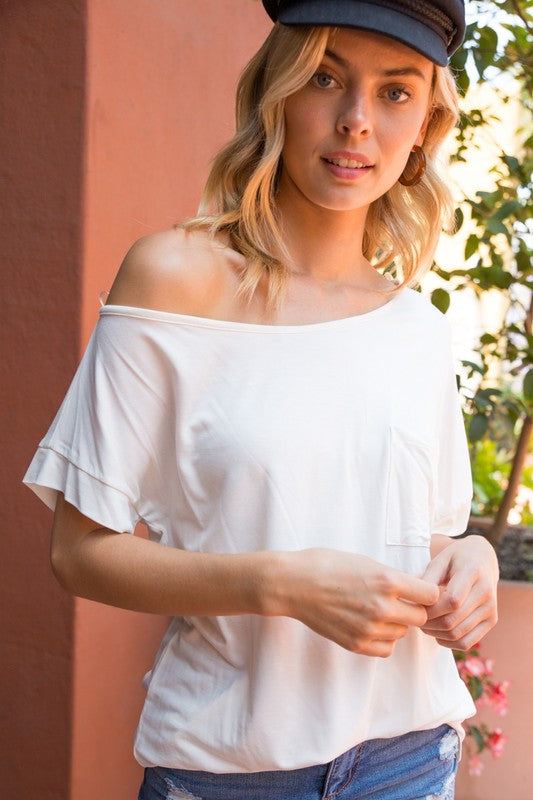 SOLID ONE SHOULDER TOPSOLID JERSEY ONE SHOULDER TOP- Solid one shoulder top- Chest pocket- Loose fit- Solid jersey- Model is 5' 8" 31-24-35 and wearing a Small- 95% RAYON, 5% SPANDEX- MAD