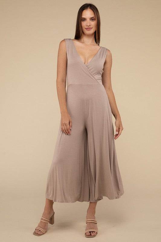 Surplice Neckline Sleeveless JumpsuitThe Surplice Neckline Sleeveless Jumpsuit exudes effortless elegance and modern sophistication. Featuring a surplice neckline, this jumpsuit offers a chic and flatte