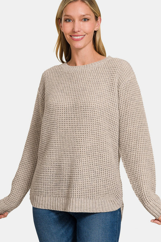 Zenana High Low Long Sleeve Waffle SweaterStay cozy and chic in this High Low Long Sleeve Waffle Sweater. With its unique waffle texture and flattering high-low hemline, this sweater is perfect for casual da