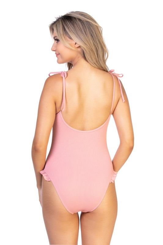 SOLID PINK FIBBED RUFFLE TRIM ONE PIECE SWIMRibbed peach one piece with ruffled trim, adjustable tie closure shoulder straps, and removable soft cups. Moderate coverage, stretch fit. 
Print / Pattern: Solid Ri