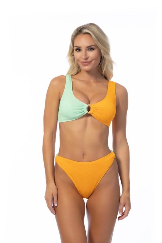 TEXTURED TWO TONE RING ACCENT BIKINI SETTwo-tone color blocking textured bikini set featuring a bandeau top with wooden ring detail and removable pads. Matching with a mid-waist two-tone bottom with wooden