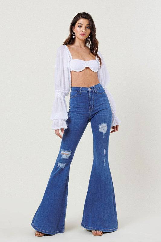 High-Rise Distressed Flare JeansMake a bold fashion statement with these High-Rise Distressed Flare Jeans. Designed for those who want to stand out, these jeans feature subtle distressing on the fr