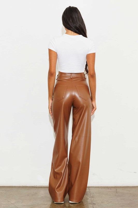 Vegan Leather Wide Leg PantsIndulge in cruelty-free chic with our Vegan Leather Wide Leg Pants. Crafted from high-quality PU, these pants showcase a modern edge with two front and back pockets,