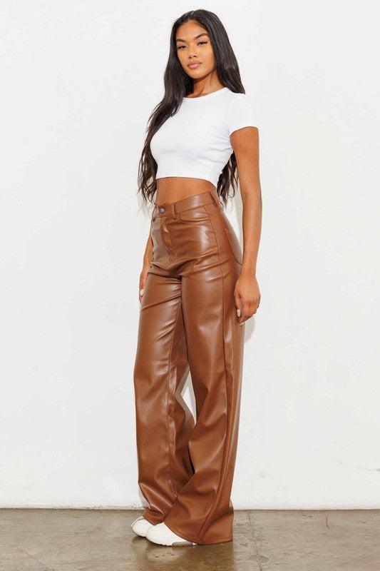 Vegan Leather Wide Leg PantsIndulge in cruelty-free chic with our Vegan Leather Wide Leg Pants. Crafted from high-quality PU, these pants showcase a modern edge with two front and back pockets,