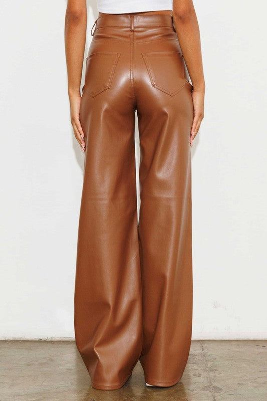 Vegan Leather Wide Leg PantsIndulge in cruelty-free chic with our Vegan Leather Wide Leg Pants. Crafted from high-quality PU, these pants showcase a modern edge with two front and back pockets,