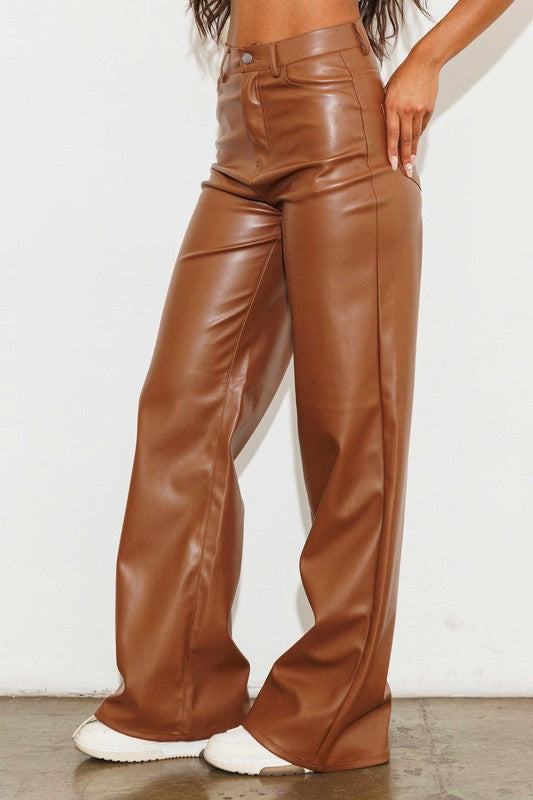 Vegan Leather Wide Leg PantsIndulge in cruelty-free chic with our Vegan Leather Wide Leg Pants. Crafted from high-quality PU, these pants showcase a modern edge with two front and back pockets,