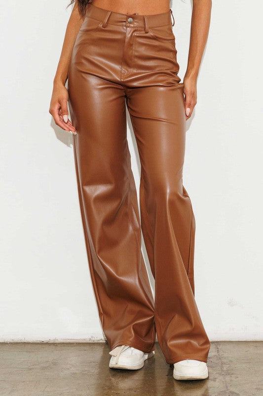 Vegan Leather Wide Leg PantsIndulge in cruelty-free chic with our Vegan Leather Wide Leg Pants. Crafted from high-quality PU, these pants showcase a modern edge with two front and back pockets,