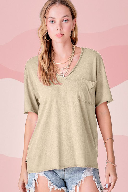 Halsey TopThe perfect tee for any style! Our effortless top featured in a boxy and super relaxed fit, short sleeves, front patch pocket, pleated back detailing, high-low hemli