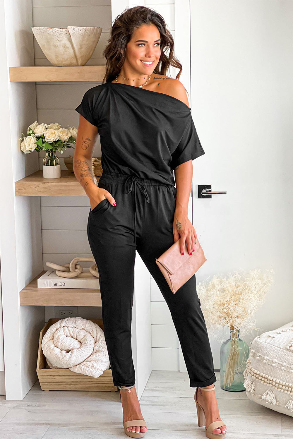 Black Tie Waist Off Shoulder Short Sleeve Tapered JumpsuitMaterial:90%Polyester+10%Elastane


	


		The short sleeves provide coverage while still allowing for ease of movement, and the tapered legs create a sleek and s