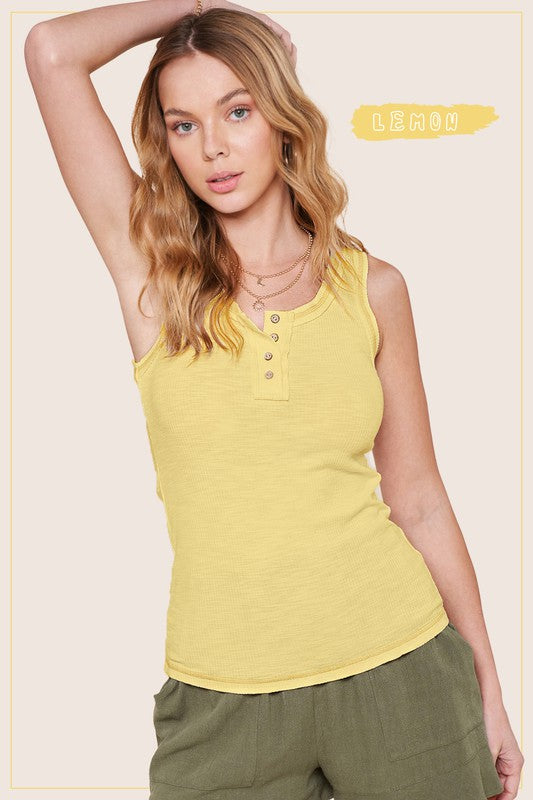 Kealy TopEffortlessly versatile ribbed cotton henley top with fitted silhouette tank with button front, contrast stitching, and exposed details.* Having trouble matching pict