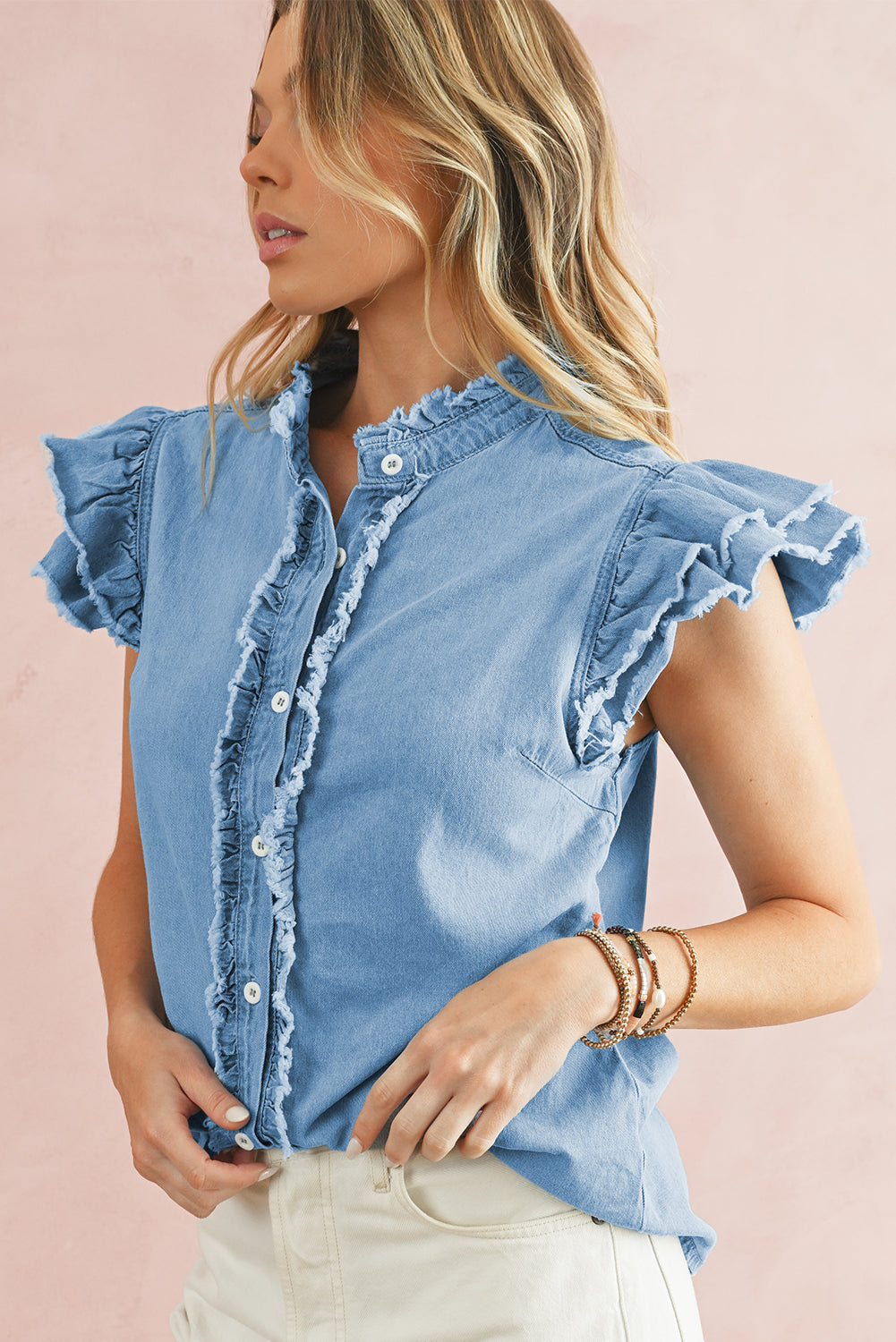 Beau Blue Button Front Ruffled Flutter Frayed Denim TopMaterial:100%Cotton



		The ruffled flutter sleeves create a playful and flirty look, adding movement and charm to the overall design.
	
	
		The frayed detaili