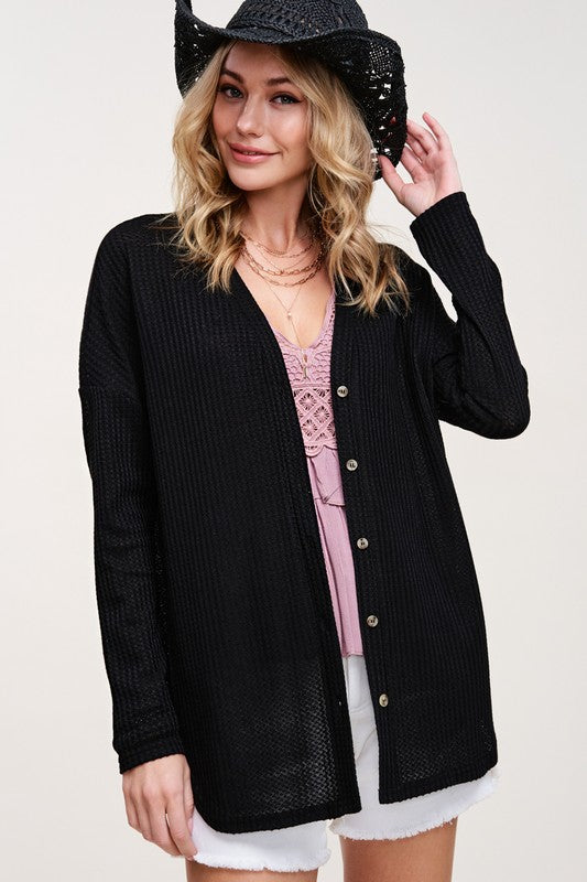 Greta CardiganWrap yourself in comfort and style with this casual cardigan made from soft and stretchy waffle fabric. It's perfect for layering or wearing on its own, making it a 