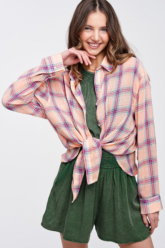 Liz ShirtA bold and stylish button-down shirt that effortlessly blends fashion and comfort. This shirt features a striking plaid print and is designed with a relaxed fit, mak