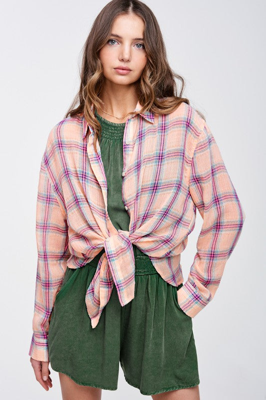 Liz ShirtA bold and stylish button-down shirt that effortlessly blends fashion and comfort. This shirt features a striking plaid print and is designed with a relaxed fit, mak