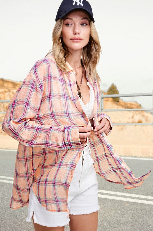 Liz ShirtA bold and stylish button-down shirt that effortlessly blends fashion and comfort. This shirt features a striking plaid print and is designed with a relaxed fit, mak