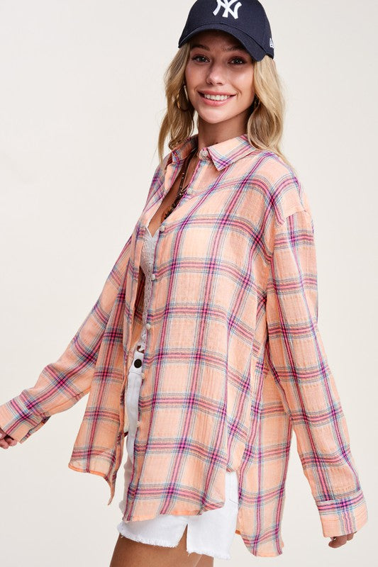 Liz ShirtA bold and stylish button-down shirt that effortlessly blends fashion and comfort. This shirt features a striking plaid print and is designed with a relaxed fit, mak