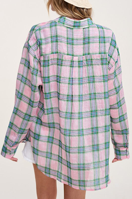 Liz ShirtA bold and stylish button-down shirt that effortlessly blends fashion and comfort. This shirt features a striking plaid print and is designed with a relaxed fit, mak