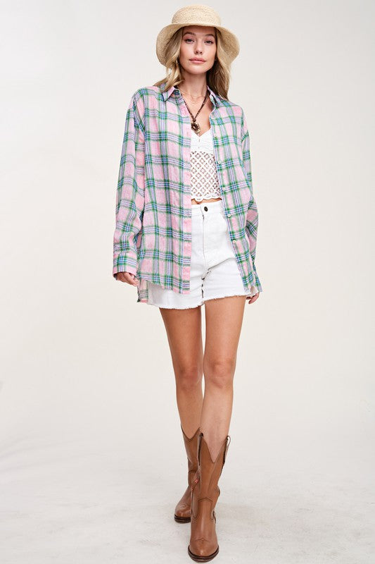 Liz ShirtA bold and stylish button-down shirt that effortlessly blends fashion and comfort. This shirt features a striking plaid print and is designed with a relaxed fit, mak