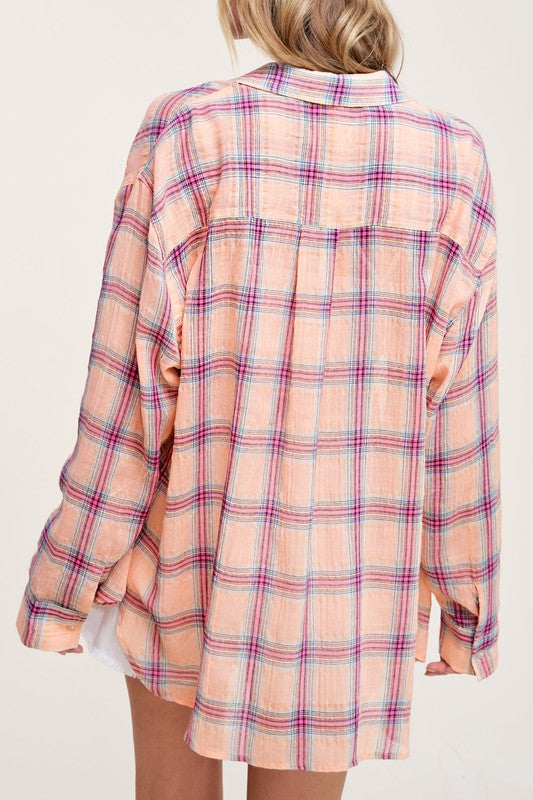 Liz ShirtA bold and stylish button-down shirt that effortlessly blends fashion and comfort. This shirt features a striking plaid print and is designed with a relaxed fit, mak