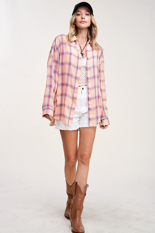 Liz ShirtA bold and stylish button-down shirt that effortlessly blends fashion and comfort. This shirt features a striking plaid print and is designed with a relaxed fit, mak