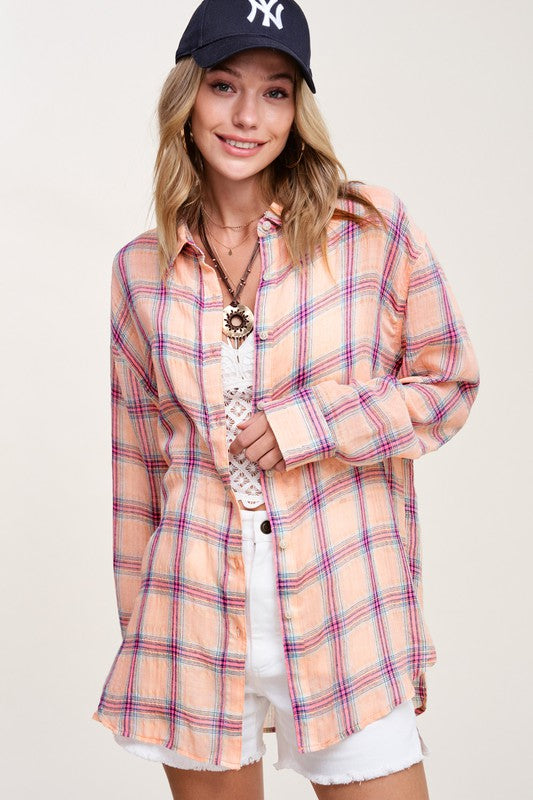 Liz ShirtA bold and stylish button-down shirt that effortlessly blends fashion and comfort. This shirt features a striking plaid print and is designed with a relaxed fit, mak