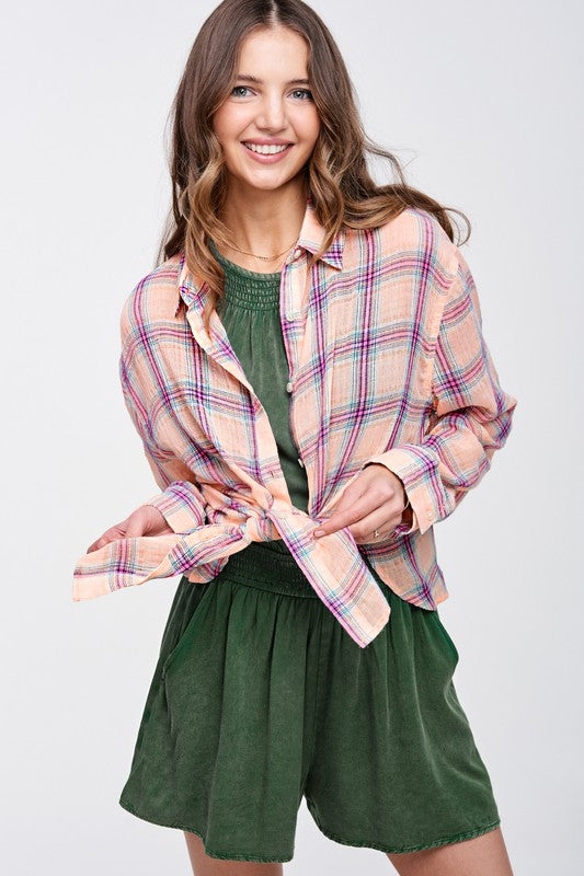 Liz ShirtA bold and stylish button-down shirt that effortlessly blends fashion and comfort. This shirt features a striking plaid print and is designed with a relaxed fit, mak