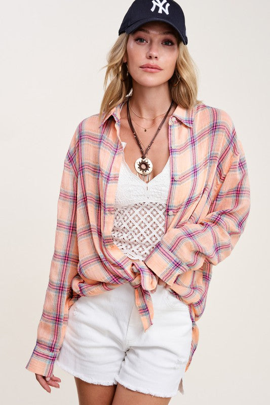 Liz ShirtA bold and stylish button-down shirt that effortlessly blends fashion and comfort. This shirt features a striking plaid print and is designed with a relaxed fit, mak