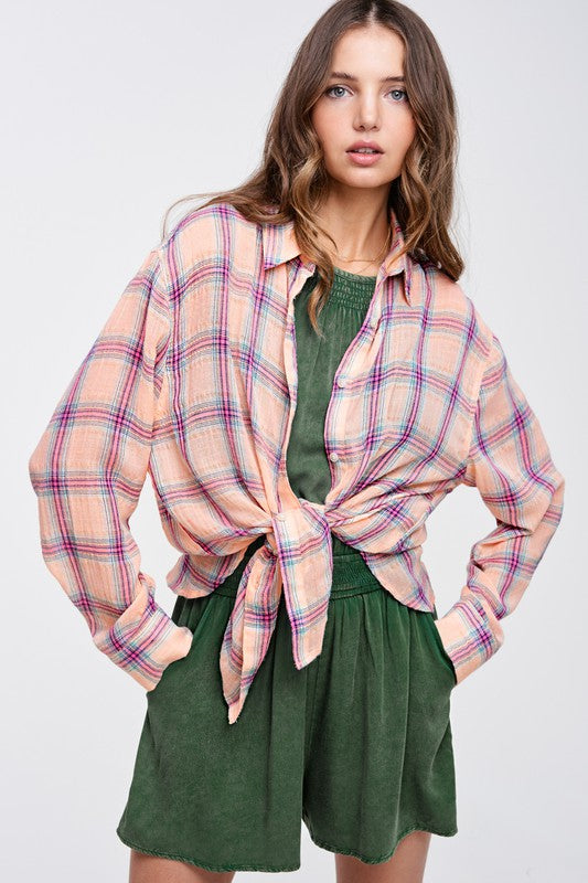 Liz ShirtA bold and stylish button-down shirt that effortlessly blends fashion and comfort. This shirt features a striking plaid print and is designed with a relaxed fit, mak