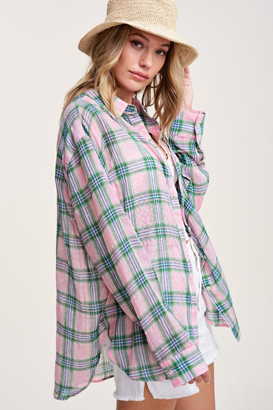 Liz ShirtA bold and stylish button-down shirt that effortlessly blends fashion and comfort. This shirt features a striking plaid print and is designed with a relaxed fit, mak