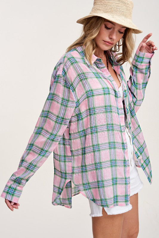 Liz ShirtA bold and stylish button-down shirt that effortlessly blends fashion and comfort. This shirt features a striking plaid print and is designed with a relaxed fit, mak