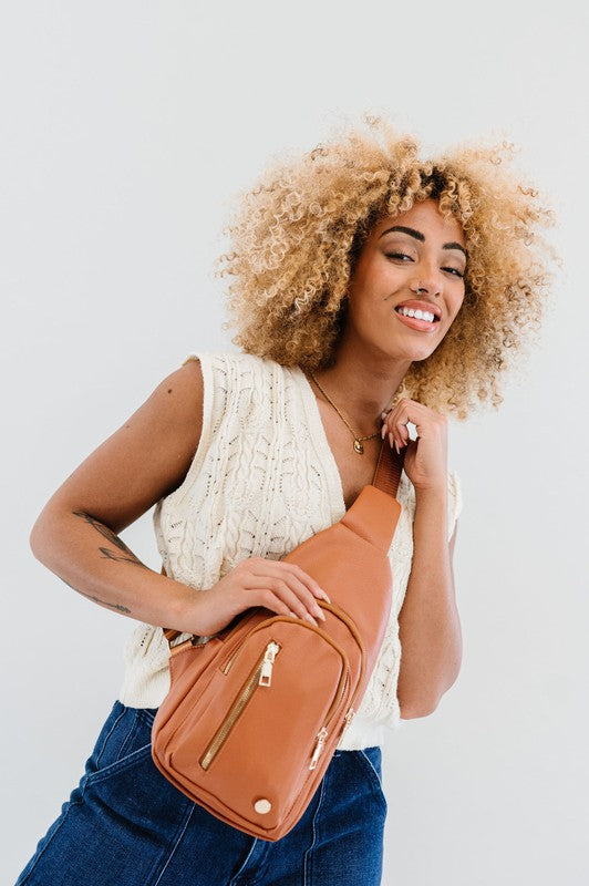 Camry Sling CrossbodyThe Camry Sling Crossbody. This silky-soft vegan leather bag fits everything you need while you're on the go, without being bulky. The front pocket zips for easy pho