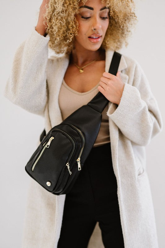 Camry Sling CrossbodyThe Camry Sling Crossbody. This silky-soft vegan leather bag fits everything you need while you're on the go, without being bulky. The front pocket zips for easy pho