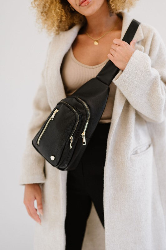 Camry Sling CrossbodyThe Camry Sling Crossbody. This silky-soft vegan leather bag fits everything you need while you're on the go, without being bulky. The front pocket zips for easy pho