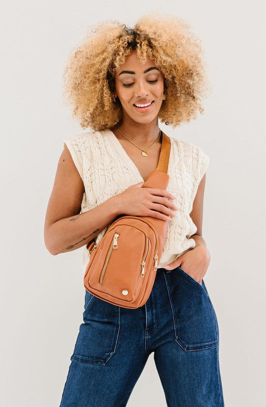 Camry Sling CrossbodyThe Camry Sling Crossbody. This silky-soft vegan leather bag fits everything you need while you're on the go, without being bulky. The front pocket zips for easy pho