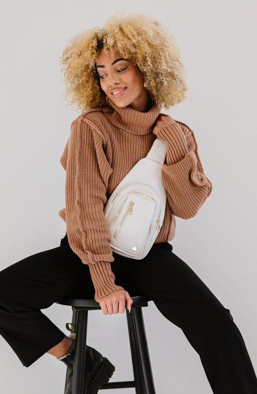 Camry Sling CrossbodyThe Camry Sling Crossbody. This silky-soft vegan leather bag fits everything you need while you're on the go, without being bulky. The front pocket zips for easy pho