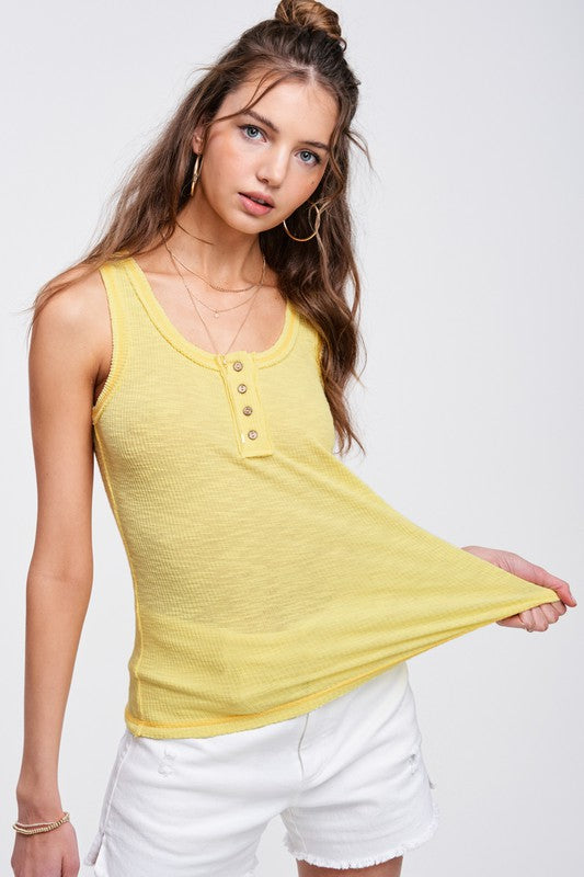 Kealy TopEffortlessly versatile ribbed cotton henley top with fitted silhouette tank with button front, contrast stitching, and exposed details.* Having trouble matching pict