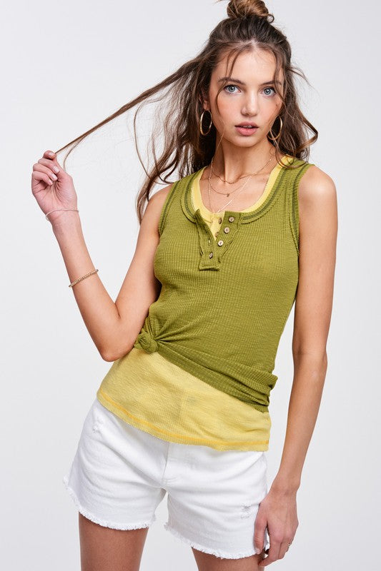 Kealy TopEffortlessly versatile ribbed cotton henley top with fitted silhouette tank with button front, contrast stitching, and exposed details.* Having trouble matching pict