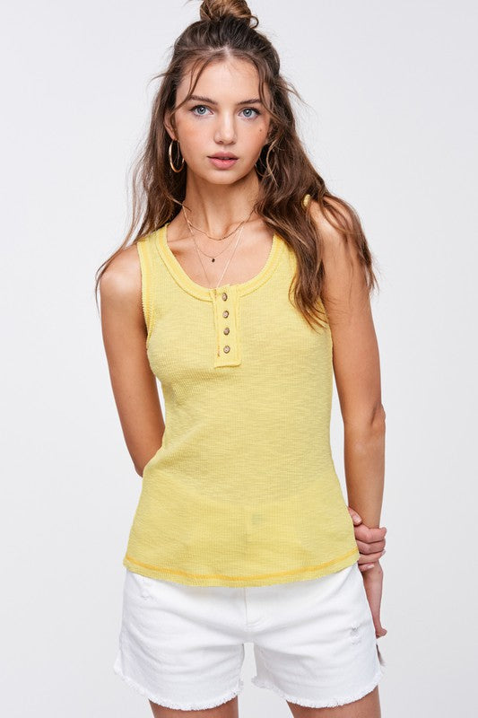 Kealy TopEffortlessly versatile ribbed cotton henley top with fitted silhouette tank with button front, contrast stitching, and exposed details.* Having trouble matching pict