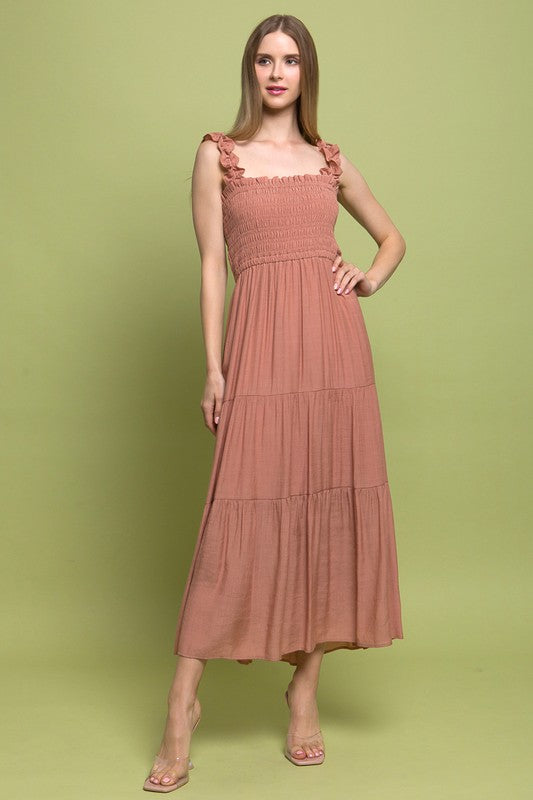 Smocked Bodice Maxi DressThe Smocked Bodice Maxi Dress is a charming and feminine piece perfect for various occasions. Its midi length, elastic strap, and smocked chest ensure a comfortable 