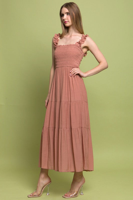 Smocked Bodice Maxi DressThe Smocked Bodice Maxi Dress is a charming and feminine piece perfect for various occasions. Its midi length, elastic strap, and smocked chest ensure a comfortable 